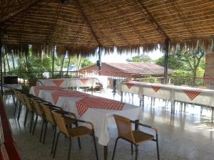 a row of tables and chairs in a restaurant at Hotel Villa Amparo in Chinauta