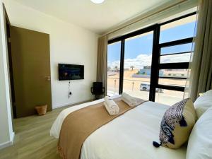 Ένα ή περισσότερα κρεβάτια σε δωμάτιο στο Dolphinbeach Escape