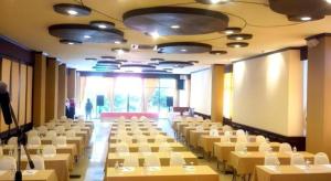 a room with rows of tables and white chairs at Phuphaya Resort Pattaya in Pattaya South +134 photos
