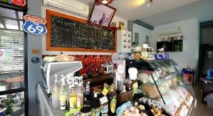 a restaurant with a counter with a chalkboard on the wall at Sixty-nine Resort in Ban Tha Khwai