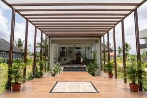 an open deck with potted plants in a house at The fox resort in Gundlupet