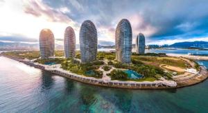 an aerial view of four towers on a island in the water at Jinjiang Inn Sanya Jiefang Road Tax Free Shopping Center in Sanya +31 photos