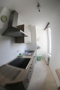 a kitchen with a sink and a stove top oven at GAUTIER 3 Etoiles in Granville