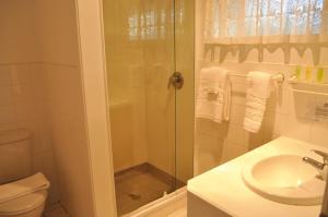 a bathroom with a shower and a sink at South Pacific Resort Hotel in Burnt Pine