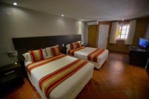 A bed or beds in a room at Hotel Posada La Sorgente