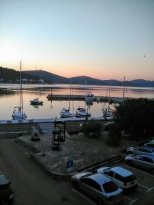 a group of cars parked in a parking lot near a marina at Apartment Vidačak in Tisno