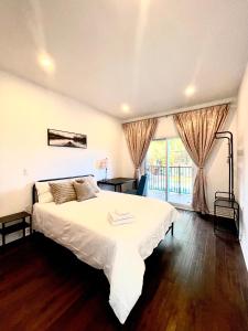 a bedroom with a large white bed and a window at Quiet King Bedroom near DT Toronto in Toronto