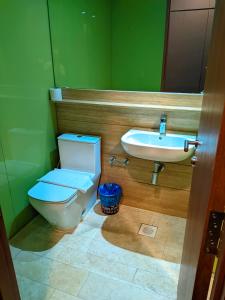 a bathroom with a toilet and a sink at Sky Suite KLCC Apartment klcc in Gua Sai +10 photos