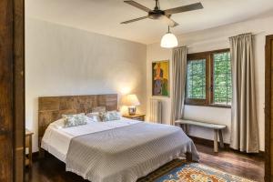 a bedroom with a bed and a ceiling fan at Casa Bali Costa Brava in Llofríu +32 photos