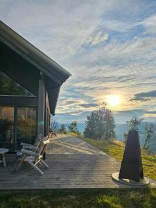 a wooden deck with a bench and a building at Mountain Cabin With Panoramic Views In Oppdal in Gorset