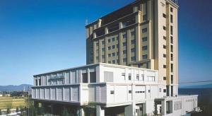 a large white building with a large at Imazu Sun Bridge Hotel in Imazu