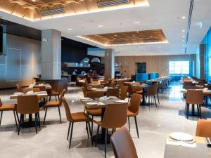 a restaurant with tables and chairs in a room at Seafest Hotel Semporna in Semporna