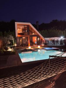 a large house with a swimming pool at night at Real Love Villas in Sapanca