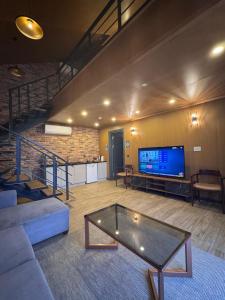 a living room with a couch and a tv at Real Love Villas in Sapanca