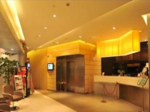 a kitchen with yellow walls and a counter in a room at Jinjiang Inn Style Xiangshan Bus Station in Xiangshan