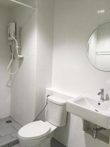 a white bathroom with a toilet and a sink at A-Port in Lat Krabang