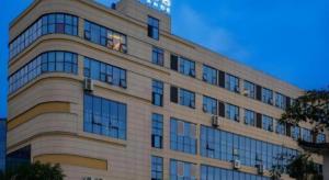 a large building with windows on the side of it at Lavande Hotel Lu County High-Speed Railway Station Wanhu Daduhui in Luzhou