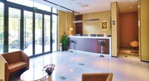 a lobby with a table and chairs in a building at IU Hotel Beijing Yuanboyuan Dujiakan in Beijing