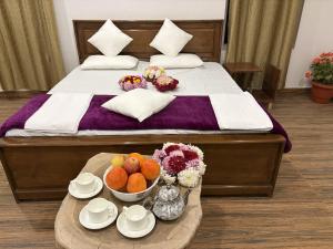 a hotel room with a bed with a tray of fruit at Kashmir Beautiful Villa in Srinagar