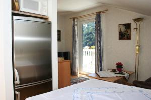 ヴィルゲンにあるFerienwohnung Großvenedigerのキッチン(ステンレス製の冷蔵庫付)、窓が備わります。