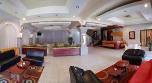 a large living room with couches and a table at Sumber Ria Hotel in Telaga