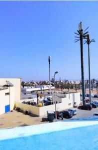 a swimming pool in front of a parking lot at Dar fati in Essaouira