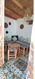 a living room with a table and a couch at Dar fati in Essaouira +12 photos