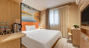 a hotel room with a white bed and a television at 7 Days Premium Zibo Jinjing Avenue the Mixc in Zibo +103 photos