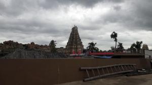 a view of a temple with a building in the background at Kiran River View Guest House in Hampi