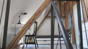 a room with a table and a chair and a lamp at La Petite Maison in Condat-sur-Vézère