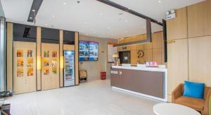a kitchen with a refrigerator and a counter in a room at IU Hotel Guiyang Convention and Exhibition Center Financial City in Jinzhuzhen