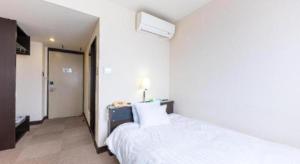 Ένα ή περισσότερα κρεβάτια σε δωμάτιο στο Tabist Hotel New Osamura Sabae