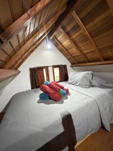 a bed with two stuffed animals sitting on it at Villa Aiden Bungalow 3 near luwatu in Ungasan