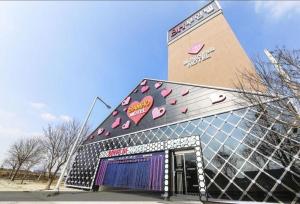 a building with hearts painted on the side of it at SH Hotel in Anggam