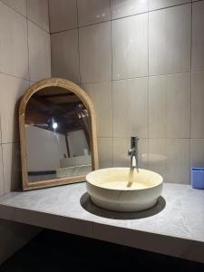 a bathroom with a sink and a mirror at Villa Aiden Bungalow 3 near luwatu in Ungasan