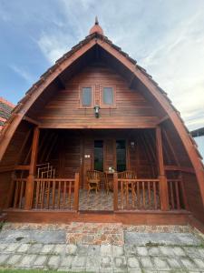 a large wooden cabin with a table and chairs at Villa Aiden Bungalow 3 near luwatu in Ungasan +14 photos