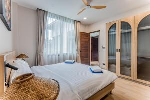 a bedroom with a large bed and a window at Modern 3 Bed Pool Villa Chaweng -Whispering Palm Villa A in Bang Rak Beach +19 photos