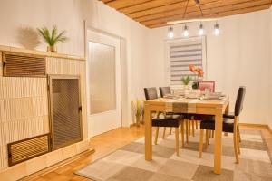 a dining room with a wooden table and chairs at Krumpes Quarters in Weiden