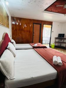 a bedroom with a large bed with towels on it at Hotel caveri comfort in Madikeri +16 photos