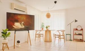 a living room with a table and chairs and a painting at Harbour Town Cozy Suite in Gold Coast