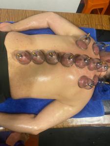 a shirtless man with a necklace of eyes on his stomach at Silver Shine Beach Resort in Kalpitiya