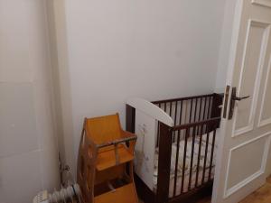 a room with a crib next to a door at Comfy apartment with 2 bedrooms in Riga