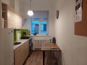 a small kitchen with a table and a sink at Comfy apartment with 2 bedrooms in Riga