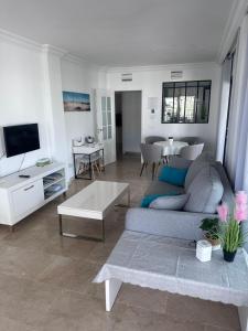 a living room with a couch and a table at Marina Real 2391 in Manilva