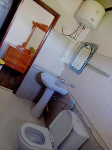 a bathroom with a toilet and a sink at Ragith Villa in Nuwara Eliya +49 photos