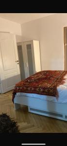 a bedroom with a bed with a blanket on it at Apartament ultracentral in Craiova