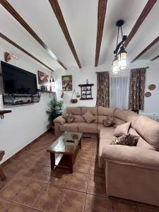 a living room with a couch and a coffee table at Casa Triana in Cuevas del Campo