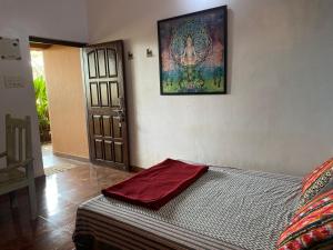 a bed in a room with a picture on the wall at Anjuna Hideout in Anjuna +69 photos