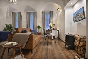 a living room with a couch and a stove at U Šuterů Boutique Hotel in Prague