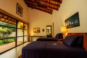 a bedroom with a bed and a desk and a window at Villa Blue Lotus Katunayake- Colombo Airport in Katunayaka +35 photos
